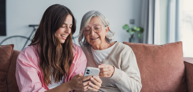Why digital services are essential to modern housing management - people smiling using phone at home